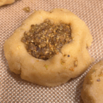 Cookie dough filed with pistachio-date filling prior to baking