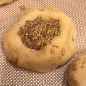 Cookie dough filed with pistachio-date filling prior to baking